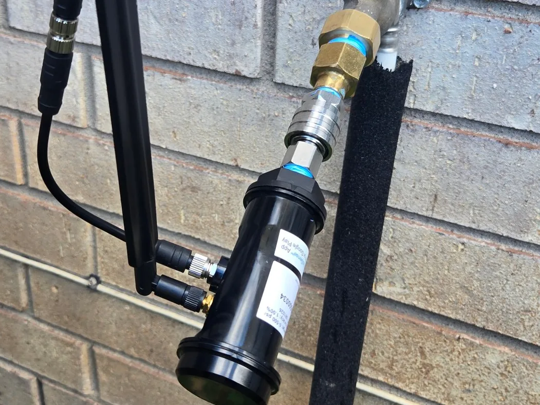 A pressure logger installed on a water line